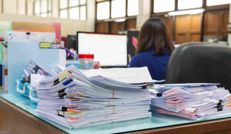 Pile of paperwork on an office desk